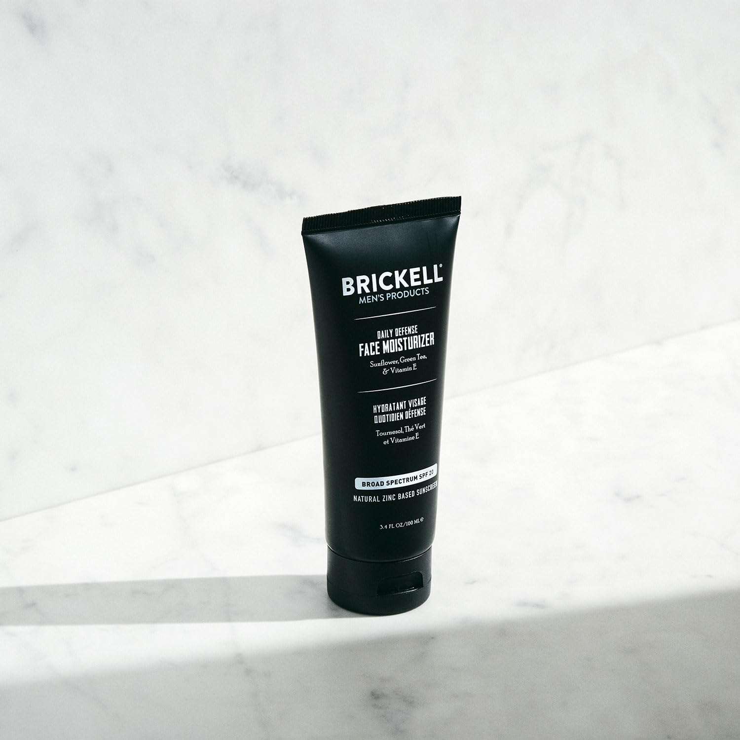 Close-up of Brickell Daily Defense texture showing light, oil-free formula.