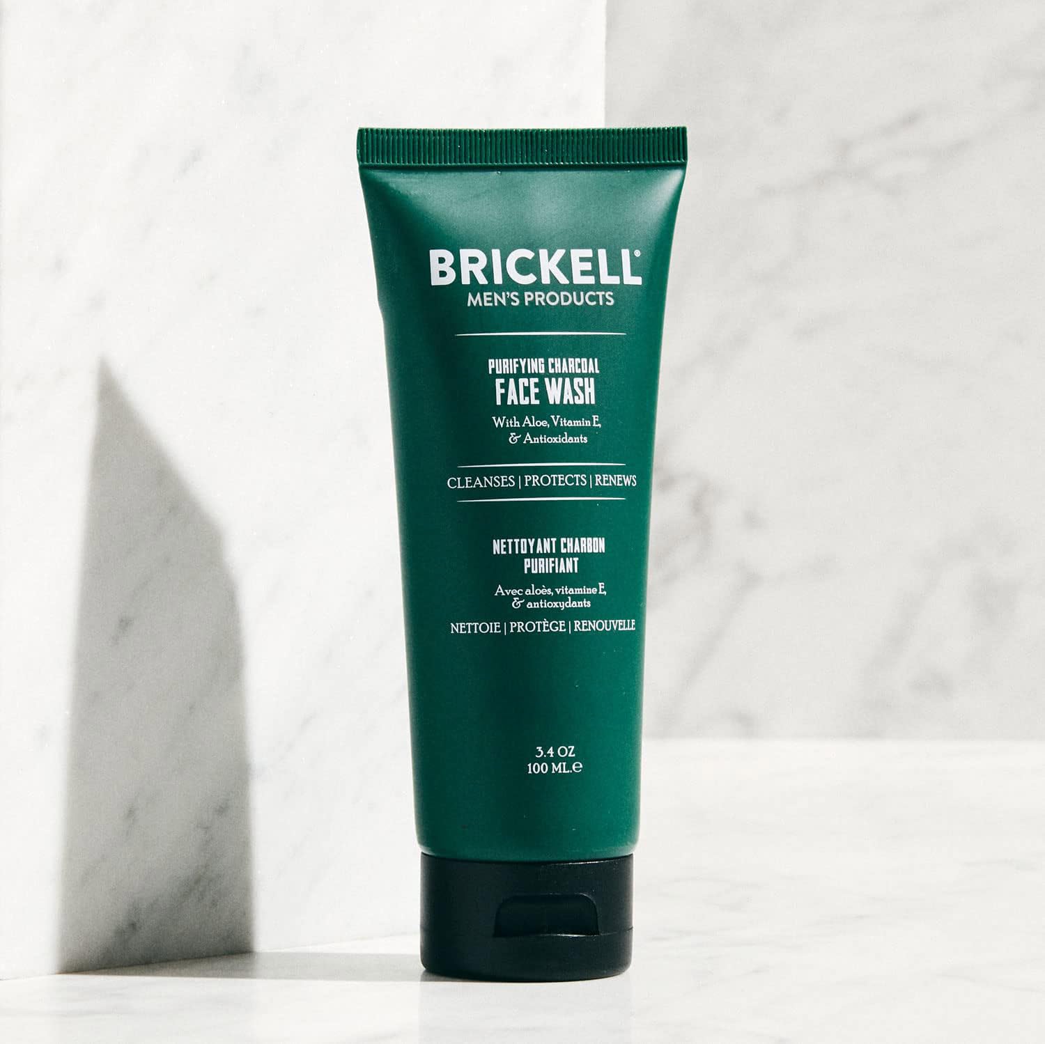 Brickell Men's Purifying Charcoal Face Wash charcoal texture close-up highlights natural cleansing formula.