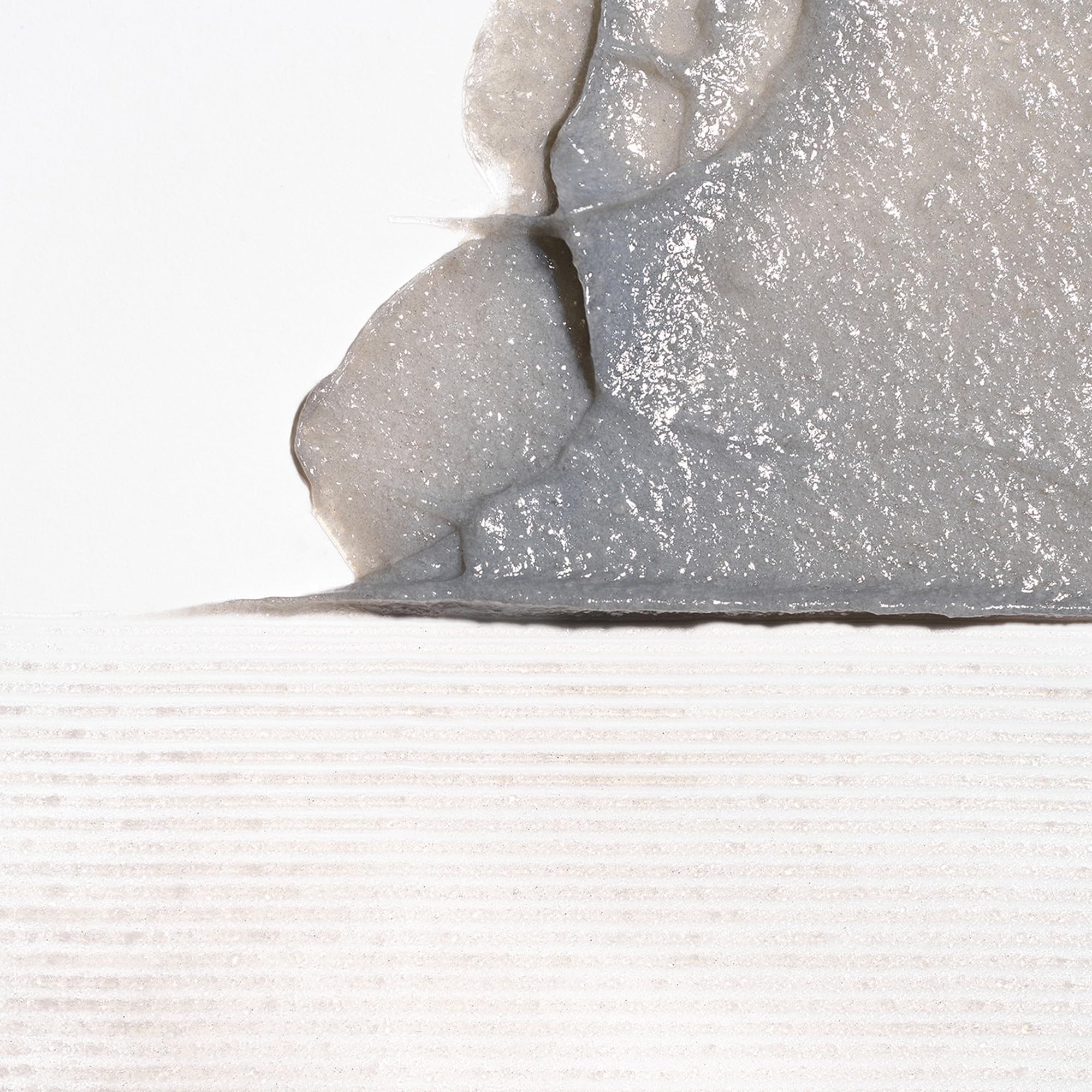 Binchotan charcoal exfoliant close-up showing plant-based micro-particles for gentle cleansing.