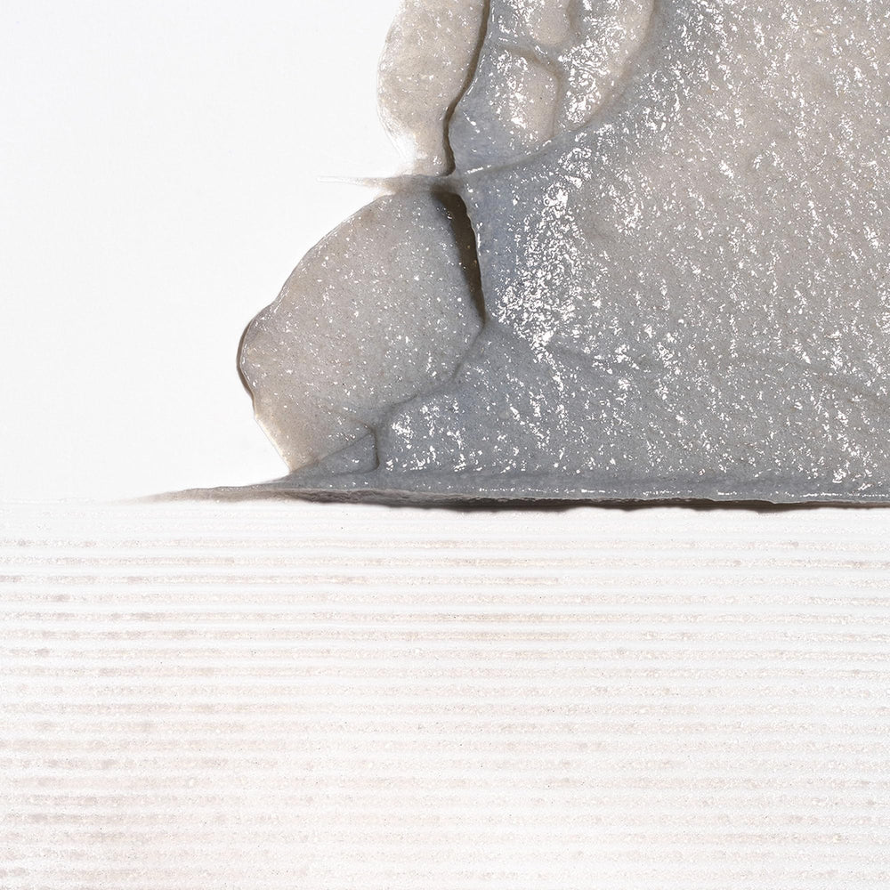 Binchotan charcoal exfoliant close-up showing plant-based micro-particles for gentle cleansing.