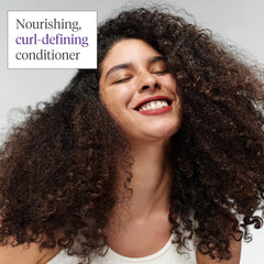 Briogeo Curl Charisma hands applying conditioner to hair