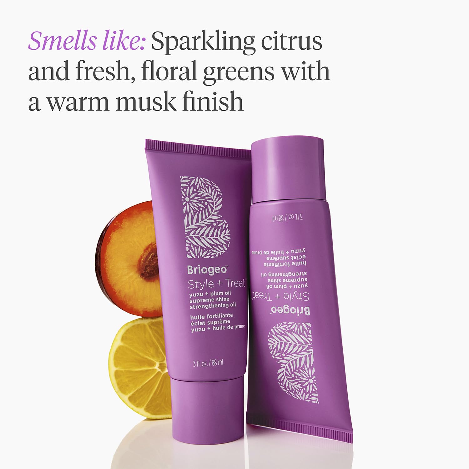 Applying Briogeo oil to dry hair to tame frizz and add shine