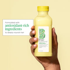 Banana extract focus on Briogeo bottle signals nourishing properties for hair.