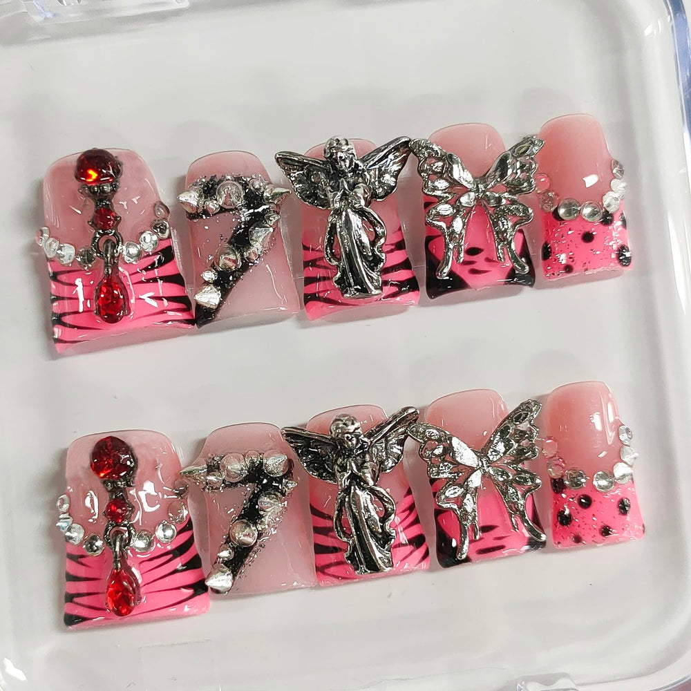 BRKYKGK nails with angel charms and rhinestones for a gothic sparkle