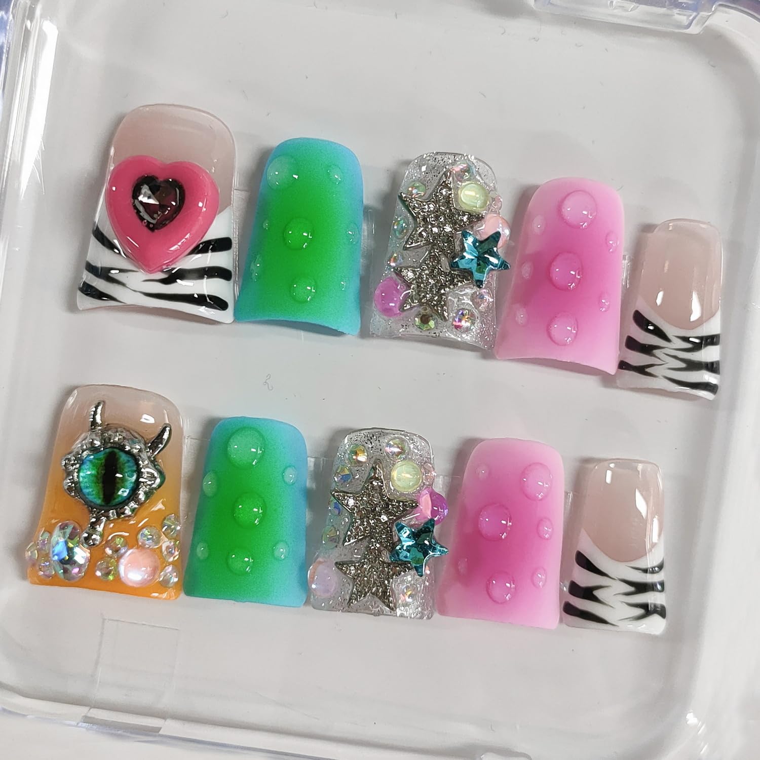 BRKYKGK nails featuring stars and rhinestones for festive style
