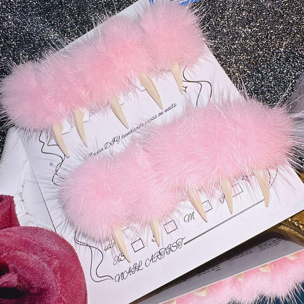 BRKYKGK nails with pink fuzzy ball design for playful party-ready style.
