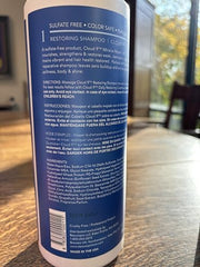 Brocato Cloud 9 Restoring Shampoo label close-up emphasizes nourishing formula.