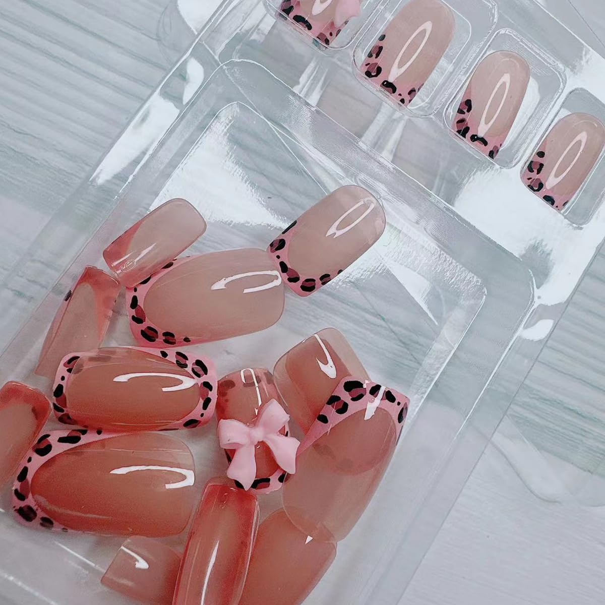 BSBTBZ leopard French tip nails on display with pink glossy bow finish