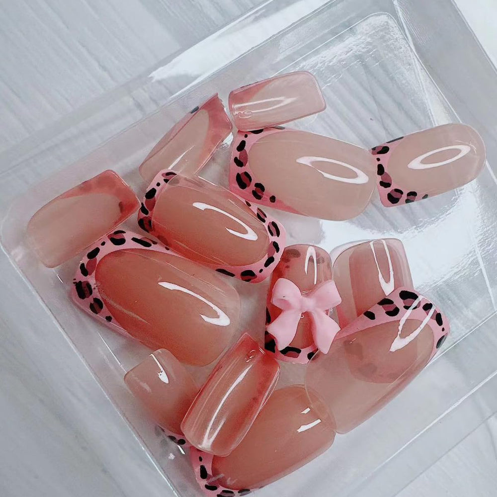 BSBTBZ leopard French tip nails with pink glossy bow in packaging