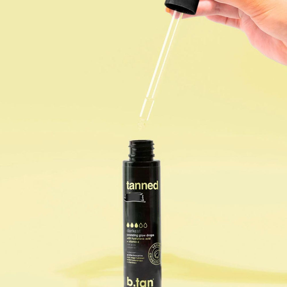 Close view of label and dropper promising a dark, hydrating tan.