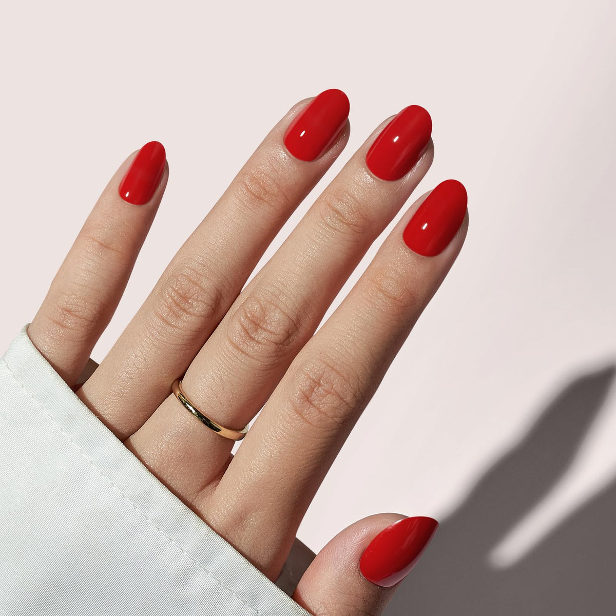 BTArtbox red oval press-on nails on a hand for quick at-home glam.