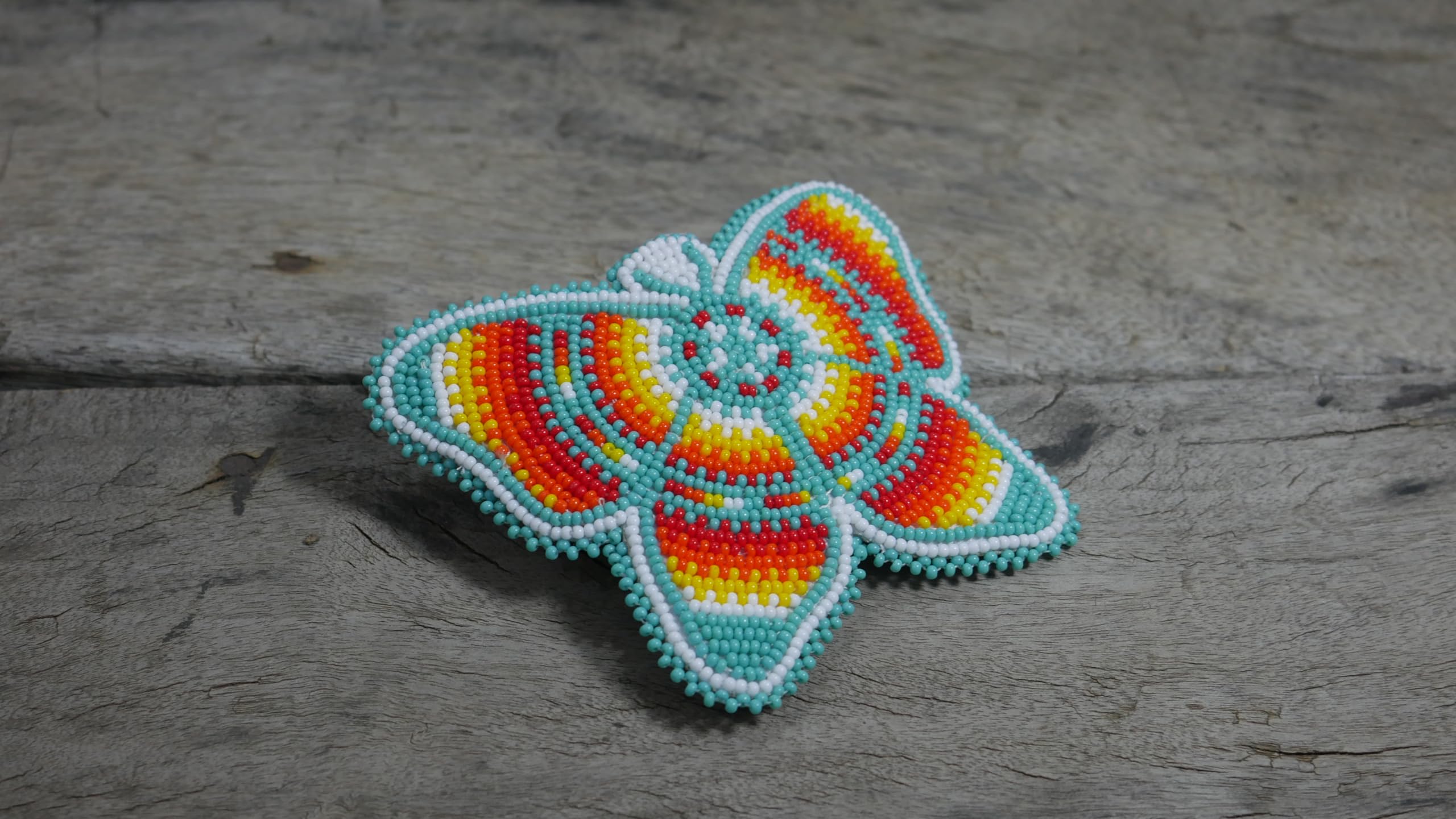 Turquoise butterfly clip features multicolored beads and a sturdy clasp