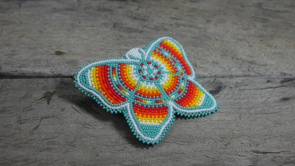 Turquoise butterfly clip features multicolored beads and a sturdy clasp