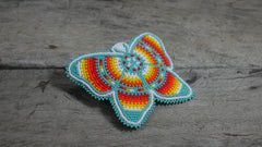 Turquoise butterfly clip features multicolored beads and a sturdy clasp