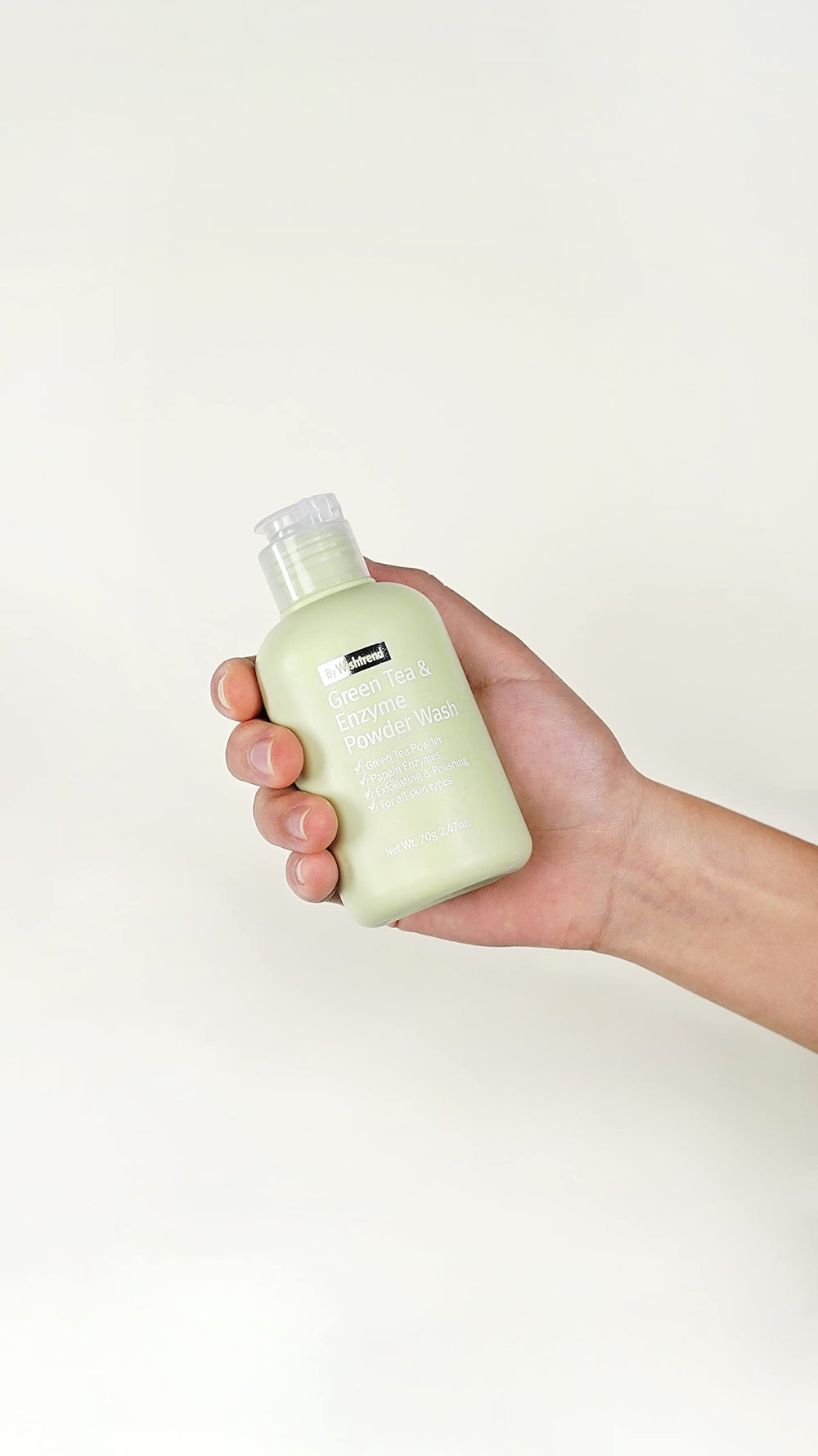 Close-up of BY WISHTREND powder wash texture with enzyme particles and green tea.