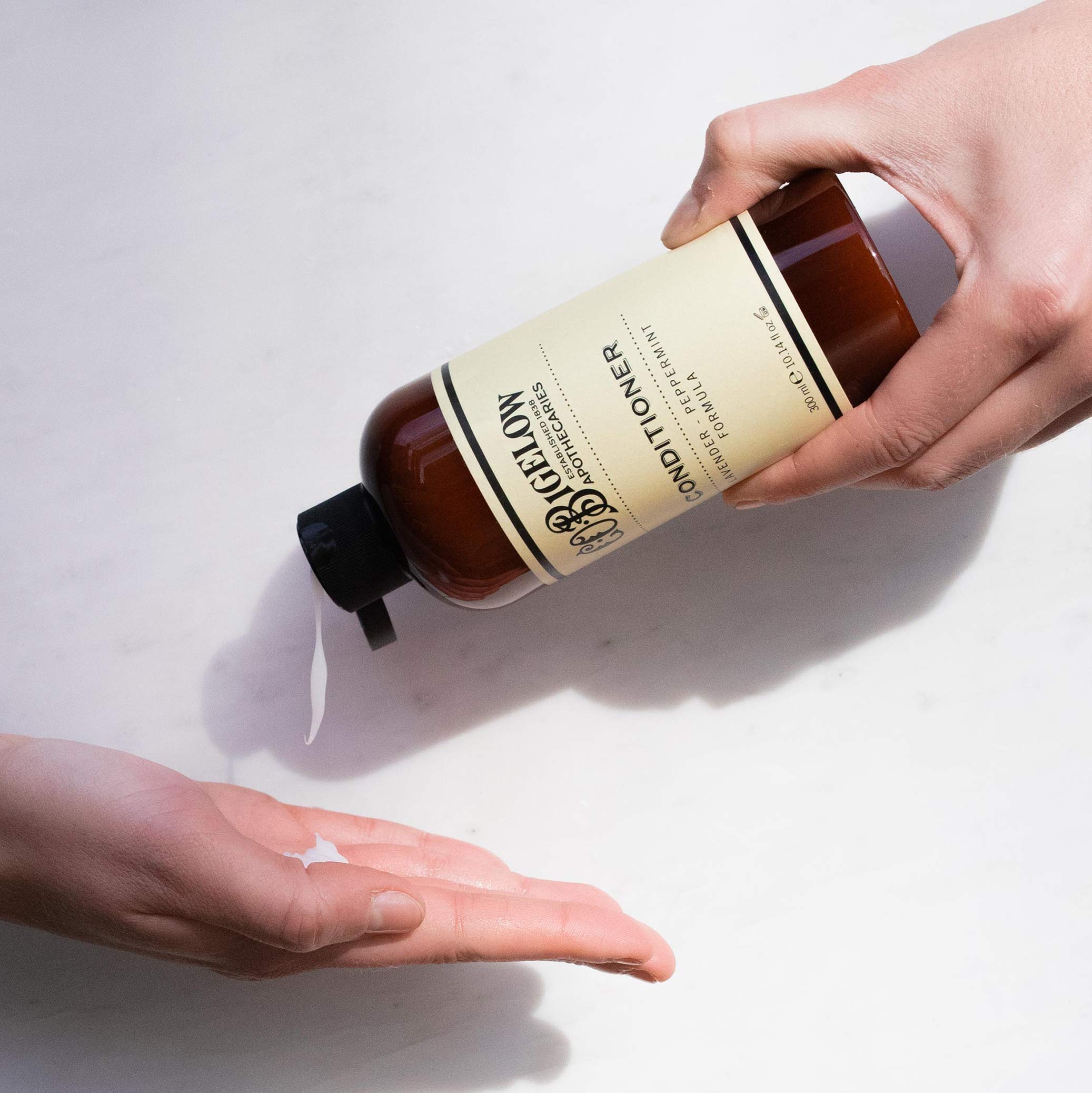 C.O. Bigelow Lavender Peppermint Conditioner lavender flowers beside bottle for soothing scent