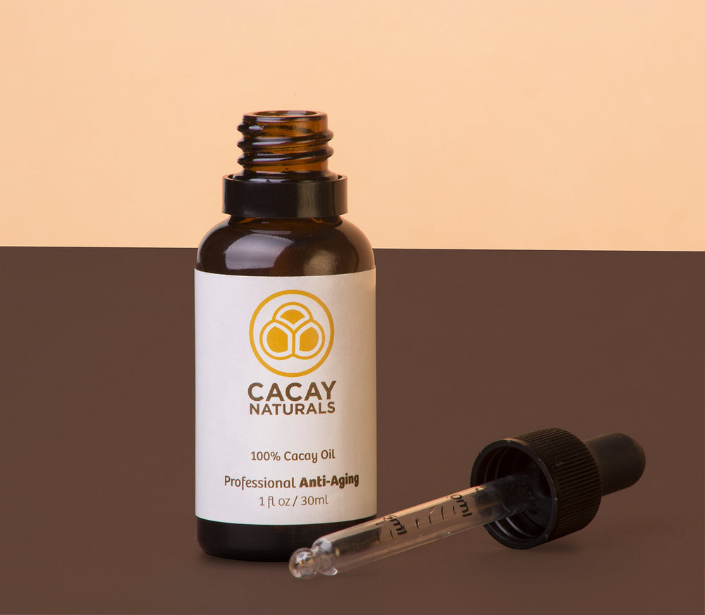 Cacay Naturals bottle in nightstand setup for evening care.