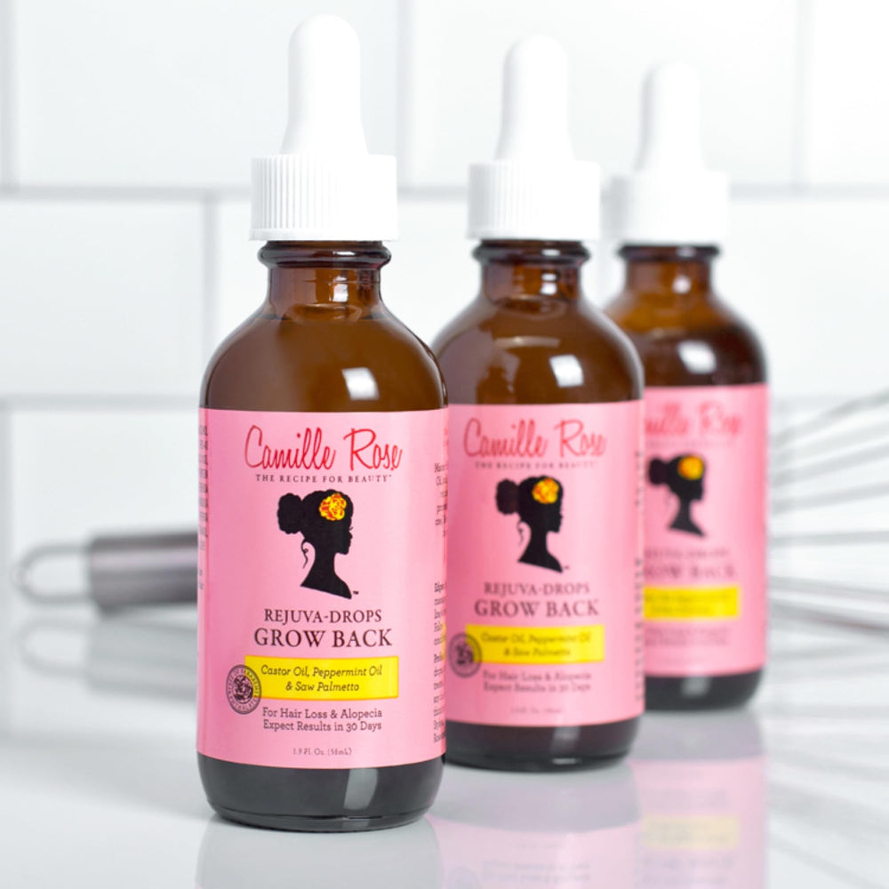Camille Rose Rejuva Grow Back Drops applied to hairline for edge care.