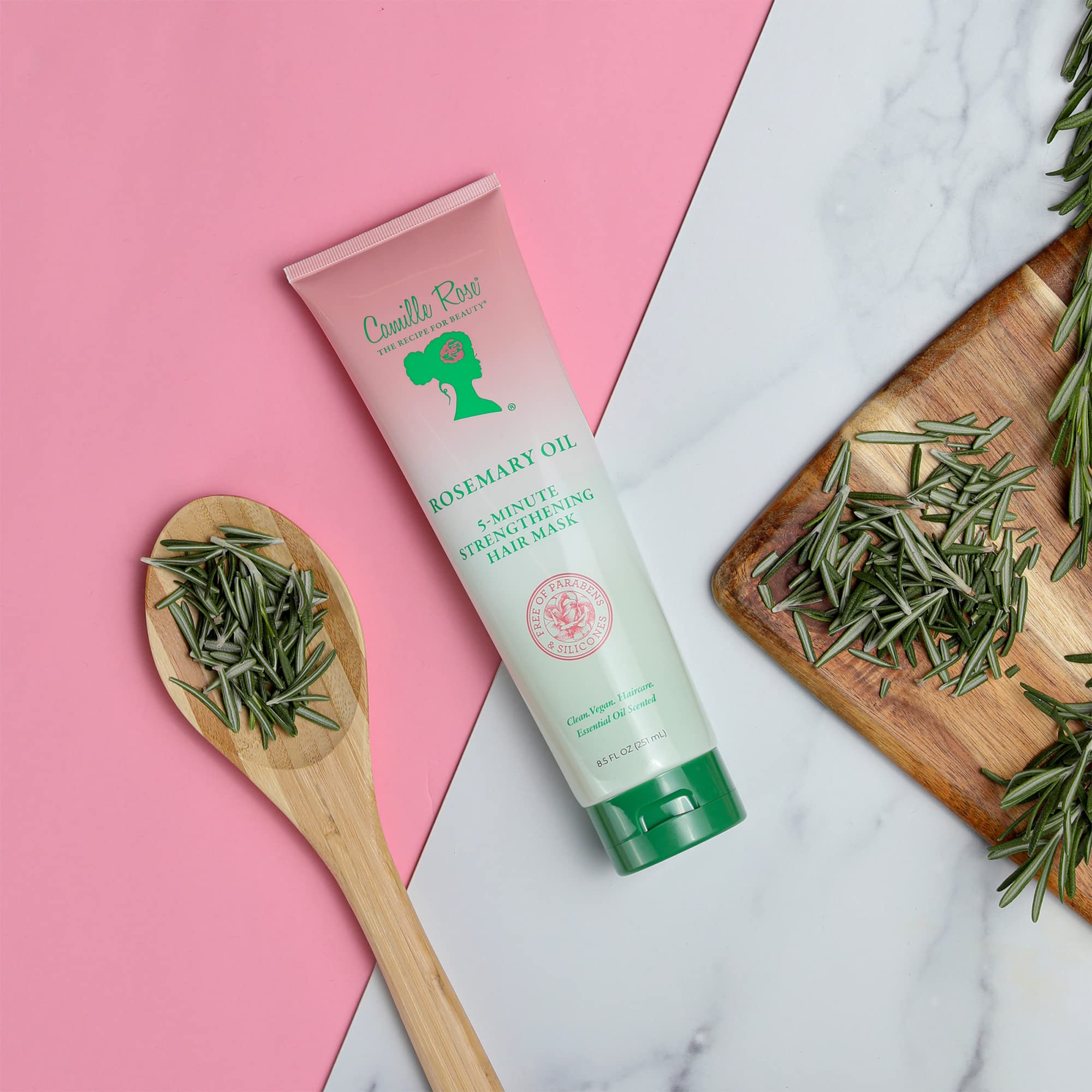Camille Rose Rosemary Oil packaging close-up emphasizes natural, gourmet formula.