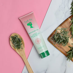 Camille Rose Rosemary Oil packaging close-up emphasizes natural, gourmet formula.