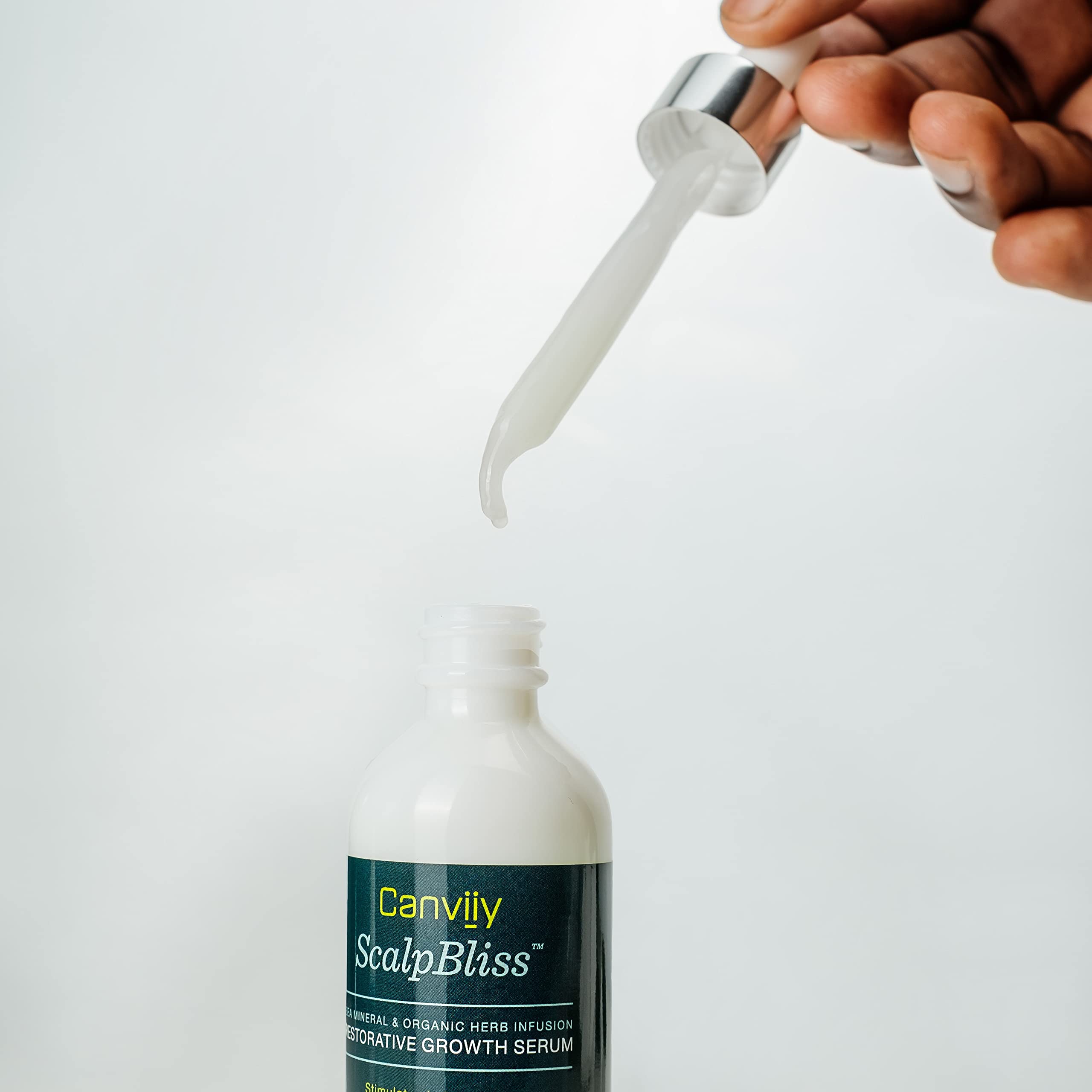 Canviiy ScalpBliss dropper applying serum to scalp for targeted hydration.