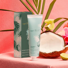 Capri Blue Flora Edit mint-green tube close-up showcases travel-size moisture for on-the-go use.