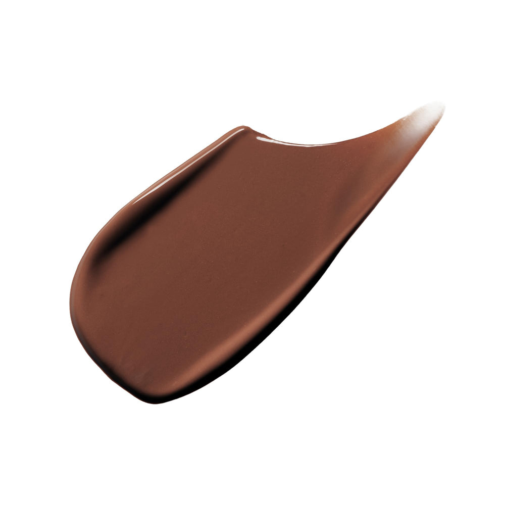 Clé de Peau Beauté Radiant Corrector for Eyes Espresso applicator in use for smooth blending.