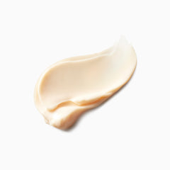 Cream on skin from Clé de Peau Beauté mini volumizing cream supreme demonstrates radiant finish.