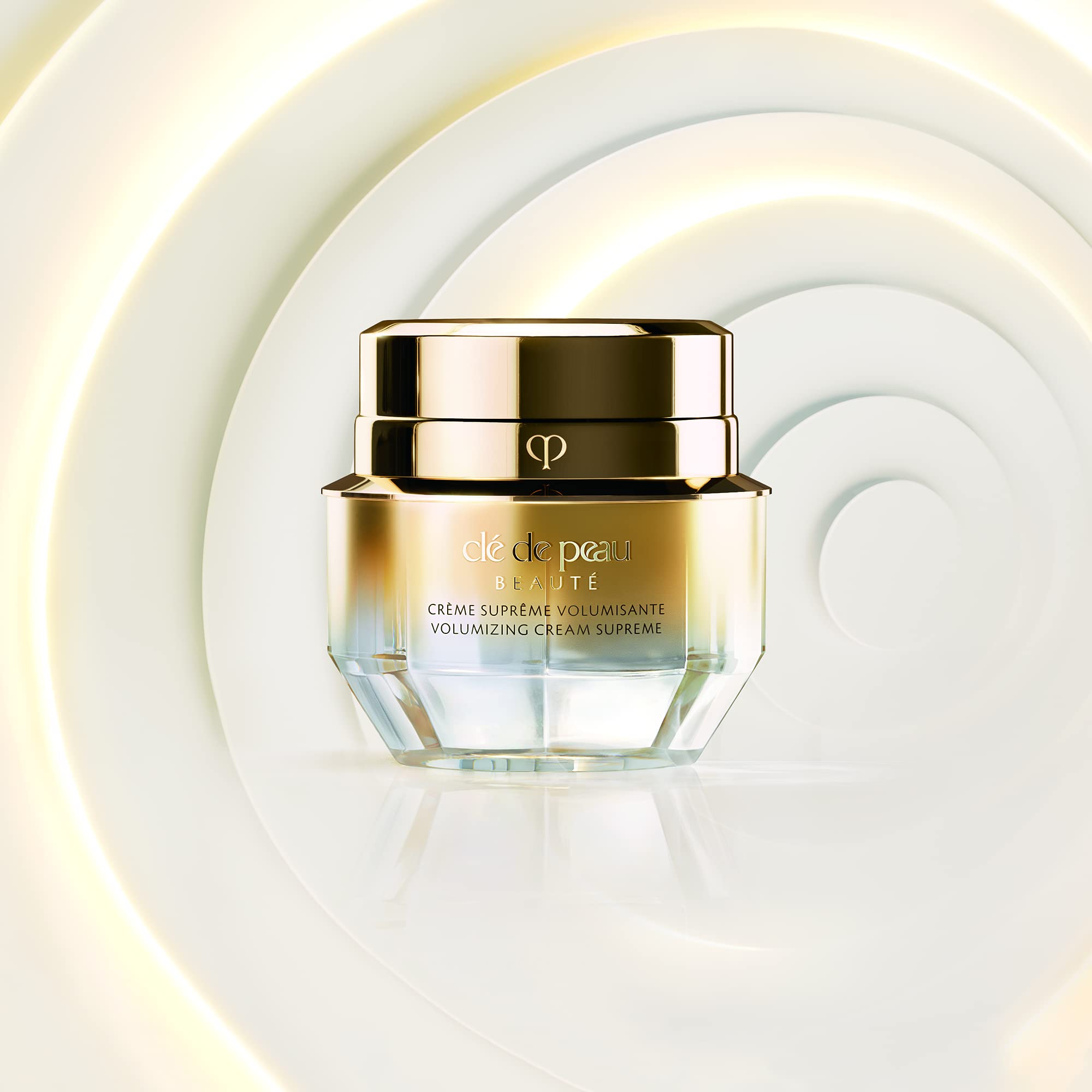 Close-up of Clé de Peau Beauté mini volumizing cream supreme silky texture on skin.