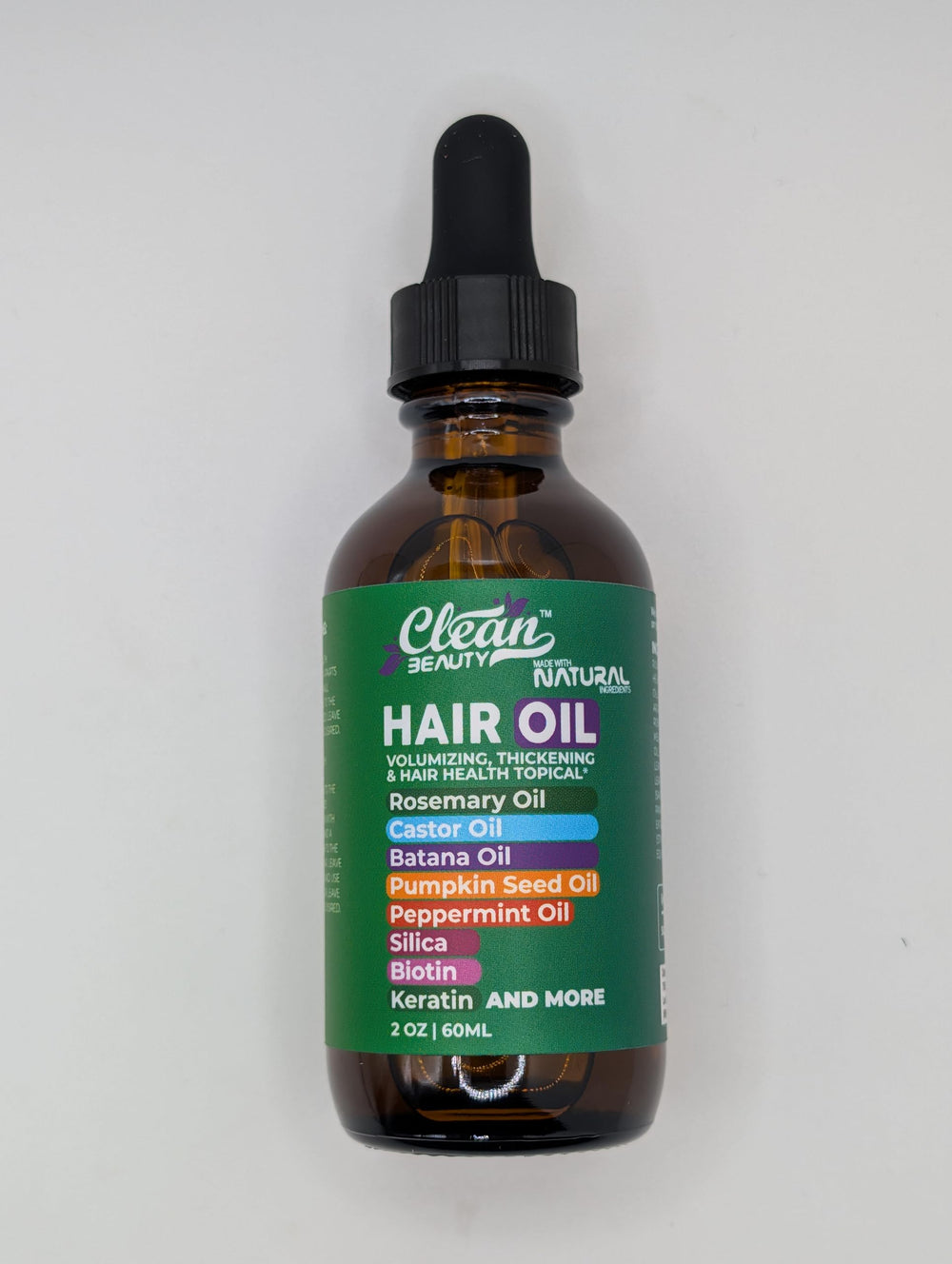 Clean Beauty dropper dispensing oil for even coverage on hair.