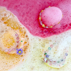Clear and Fresh donut bath bomb pour effect shows gentle fizz in warm water.