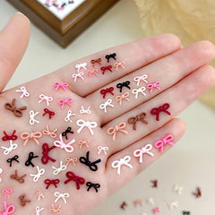 CnSybaris bow nail charms pack adds vibrant color for striking manicures.