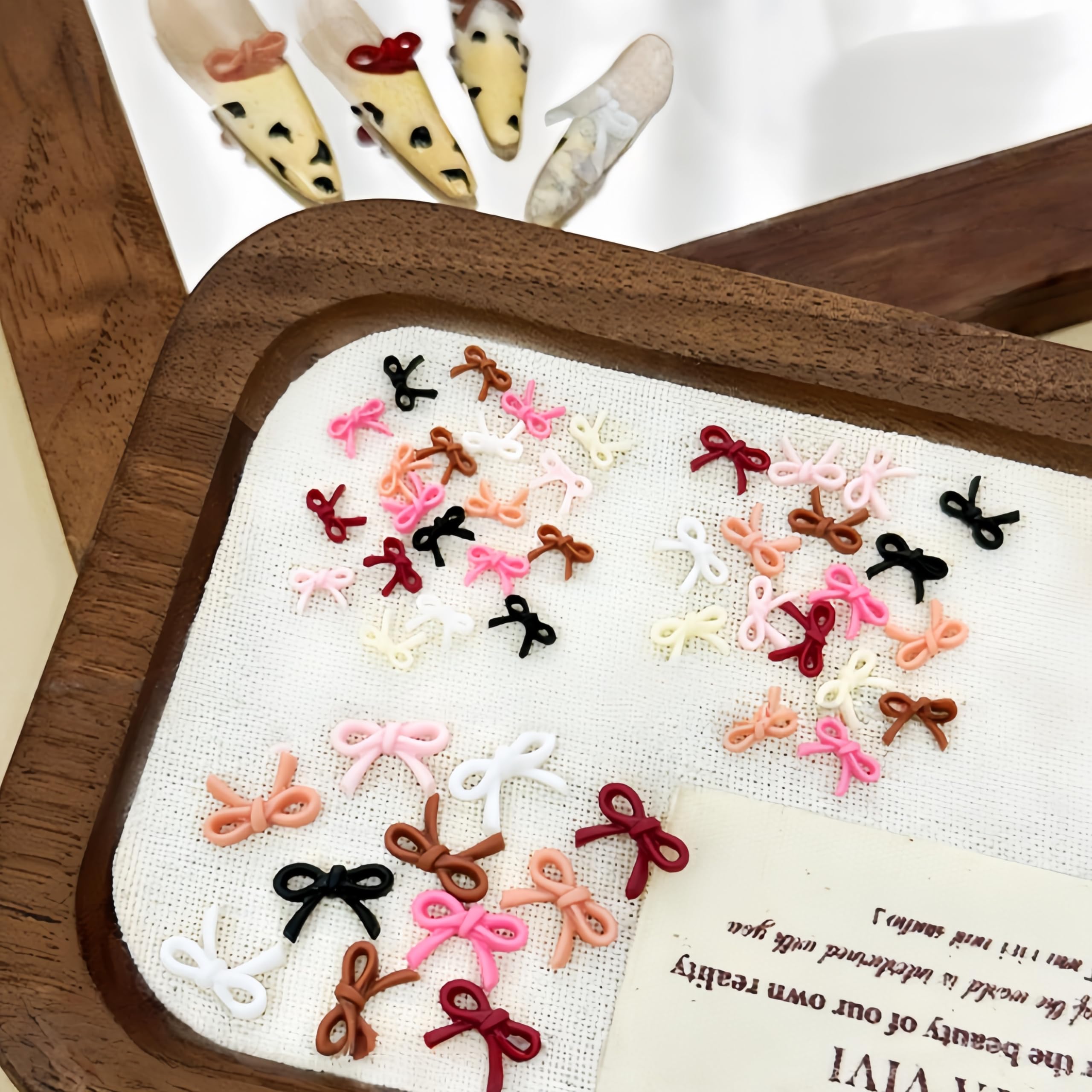 CnSybaris resin mini bow rhinestones provide shiny, elegant nail embellishments.