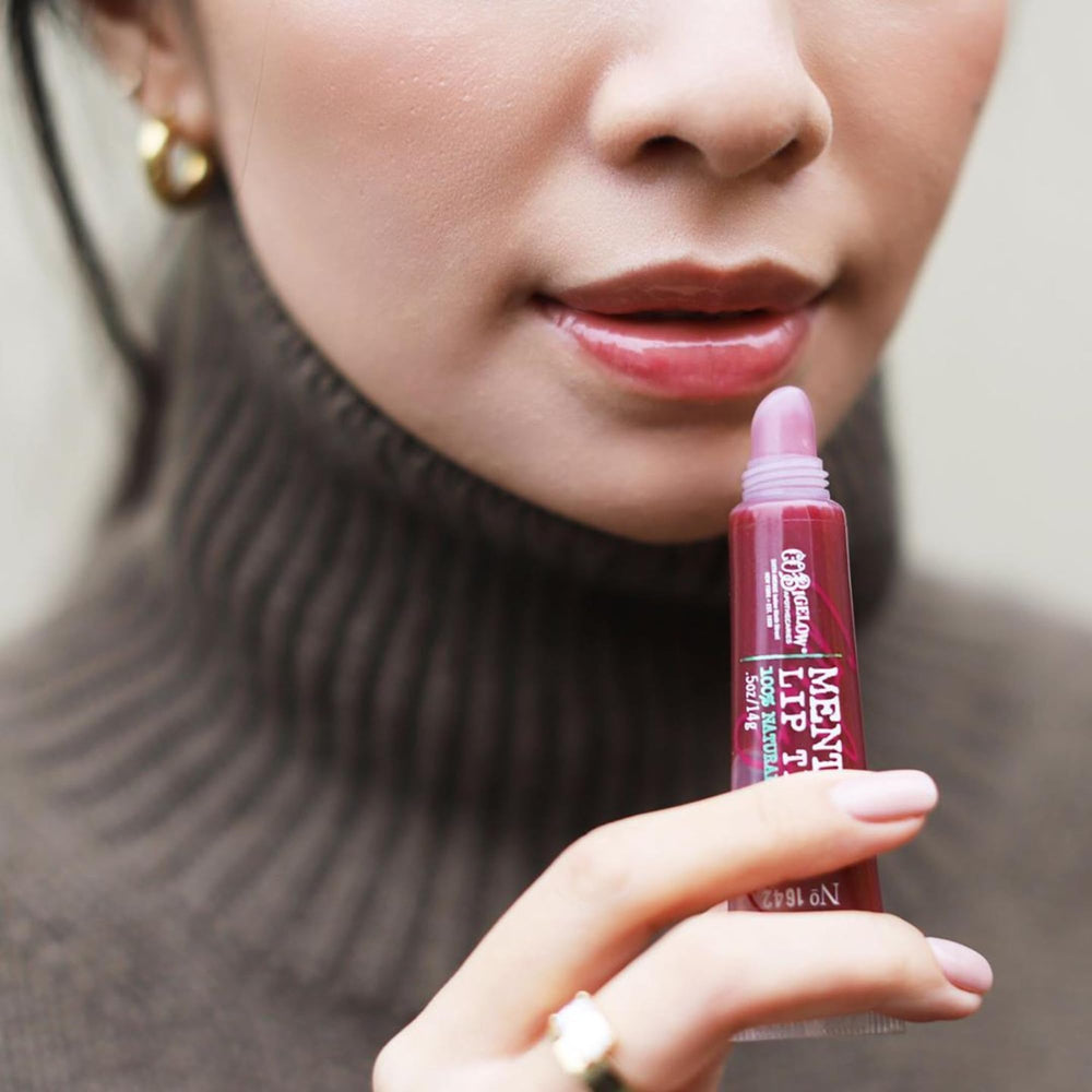 Close-up of Plum Mentha gloss showing sheer purple tint and high-gloss finish