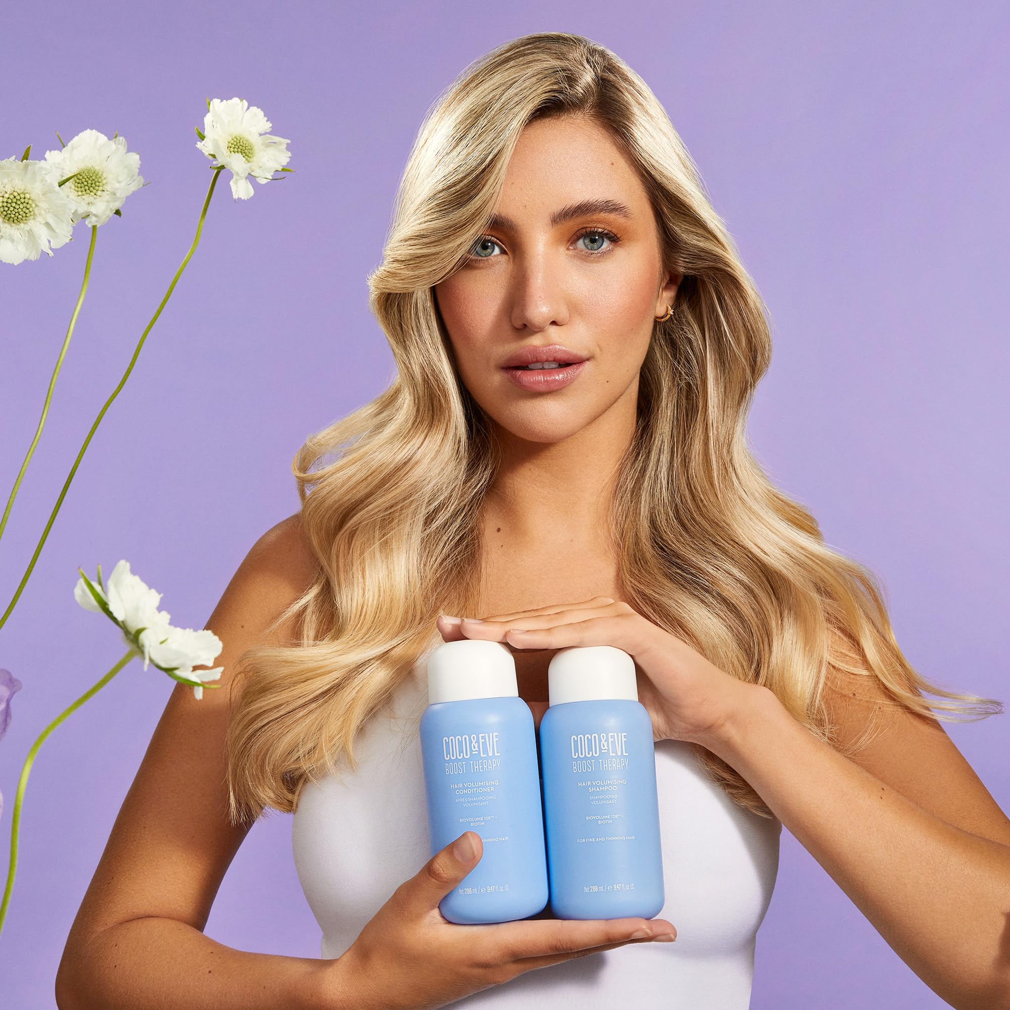Coco & Eve Boost Therapy bottle back view emphasizes premium packaging and biotin benefits.