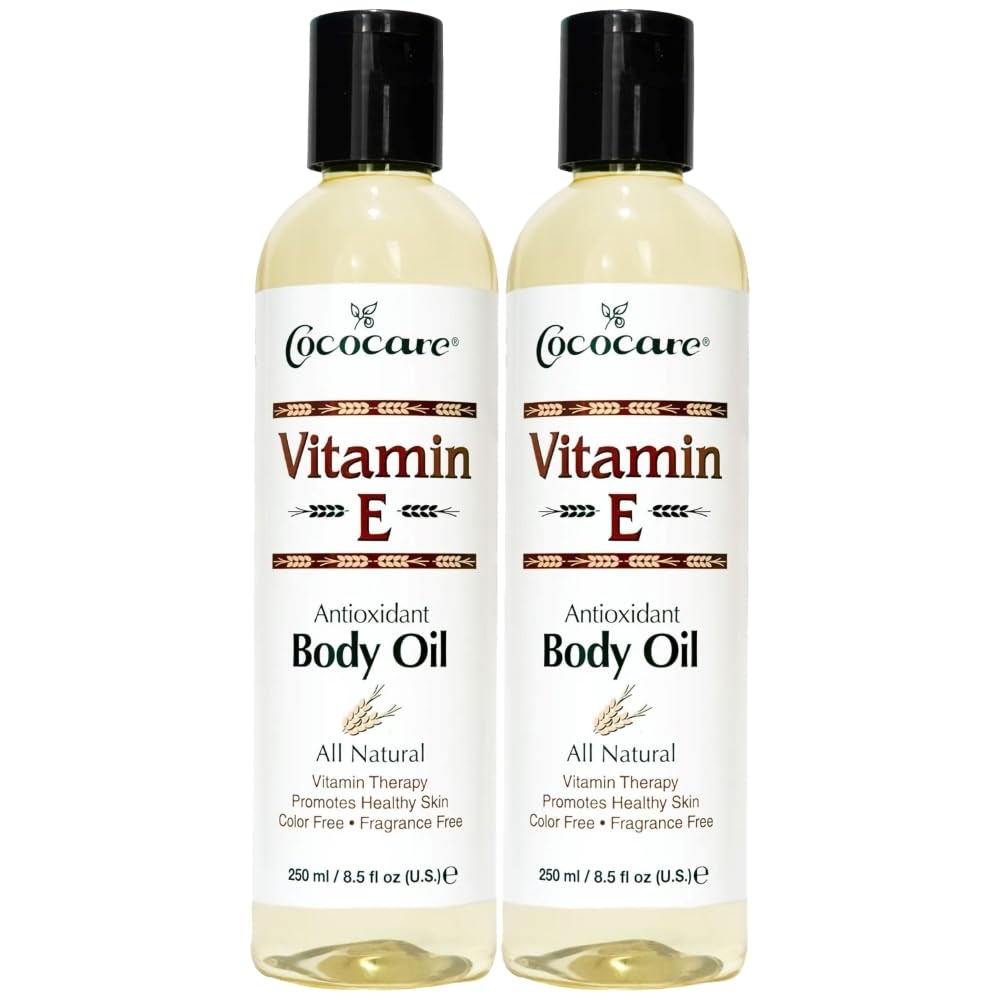 COCOCARE Vitamin E body oil bottle at an angle highlighting hydration for all skin types.