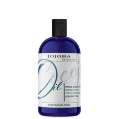 Cocojojo Jojoba Oil bottle closeup shows pure, cold-pressed care for skin and hair.