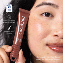 Cocokind lip blur balm application shows smooth glide on sensitive lips.