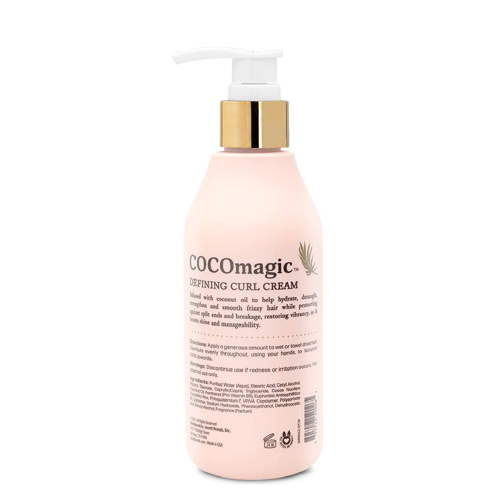 Hands applying Defining Curl Cream to detangle and define curls.