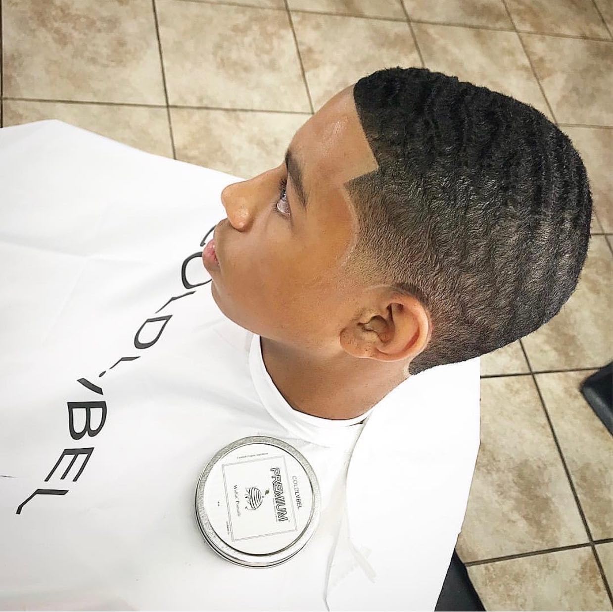 Hands applying COLDLABEL Wolfin' Pomade for smooth waves and definition