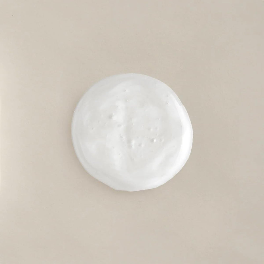 COLLEEN ROTHSCHILD Renew & Replenish Shampoo bottle close-up highlights biotin for stronger strands.