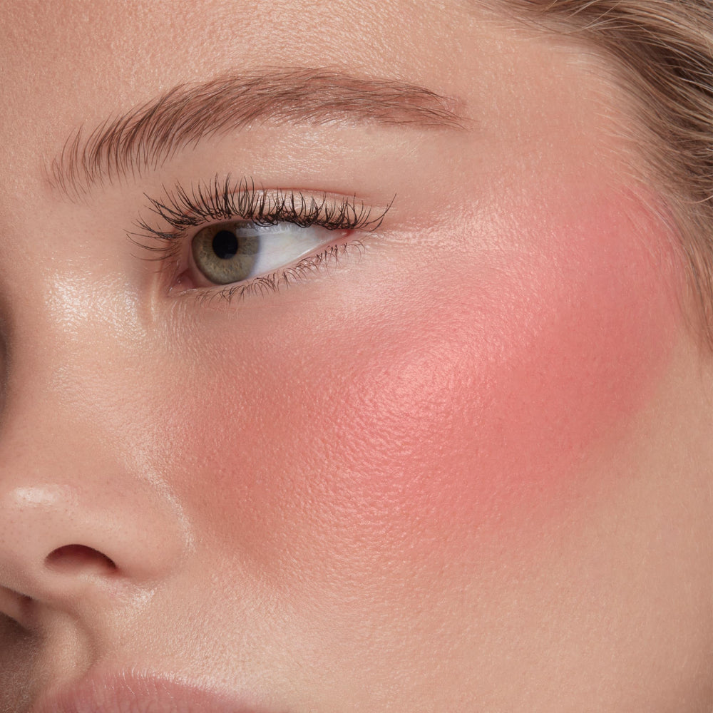 ColourPop Weightless Liquid Blush swirled on skin for buildable color.