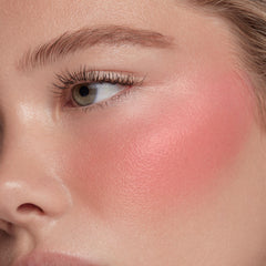 ColourPop Weightless Liquid Blush swirled on skin for buildable color.