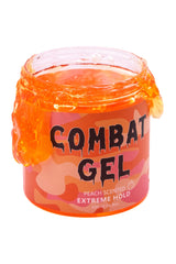 Combat Gel peach-bottle close-up highlighting the alcohol-free formula for lasting style.