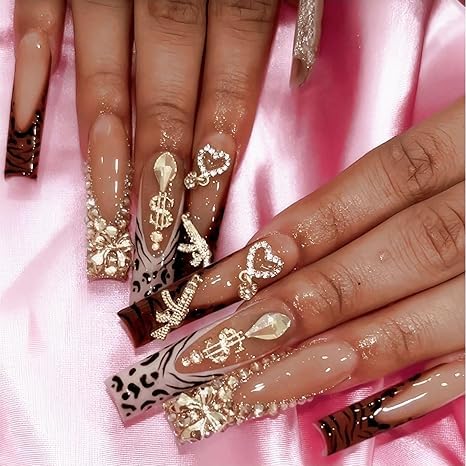 COOSLIM rhinestone charms enhance glittery detail in nail art.