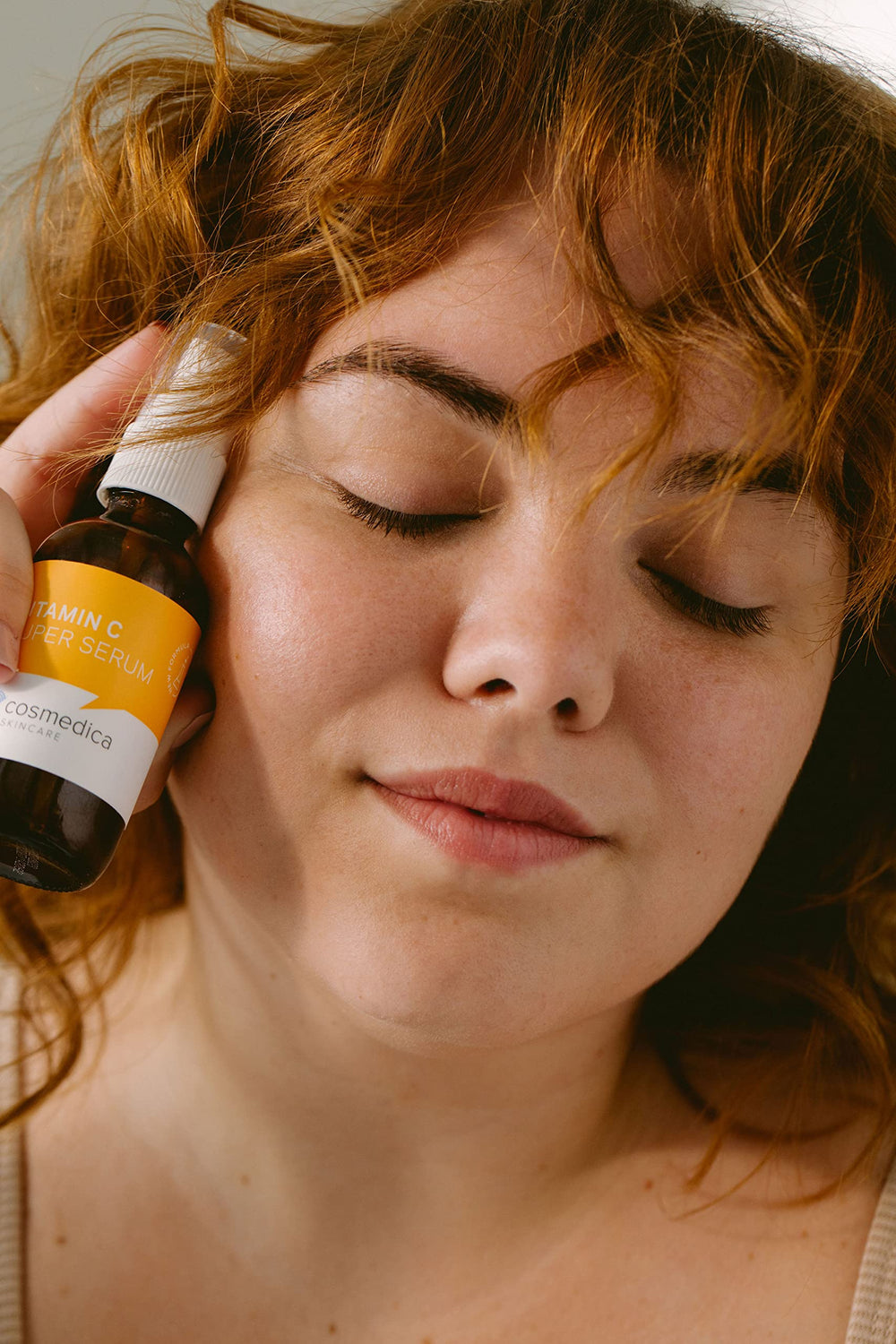 Cosmedica Vitamin C Super Serum on hand demonstrates silky texture.