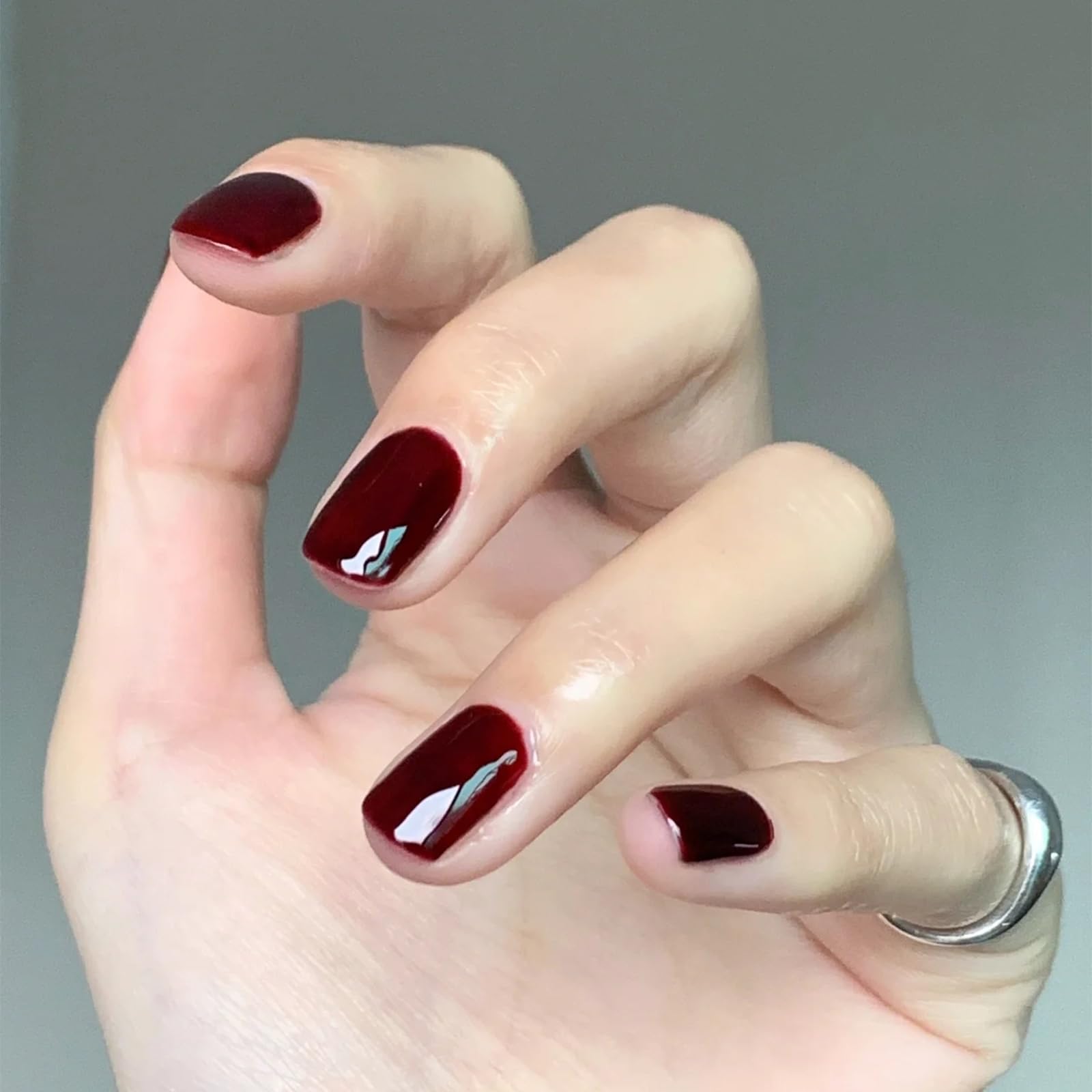COSMOO Cherry Red Nail Polish manicure scene with bright, durable color on nails.