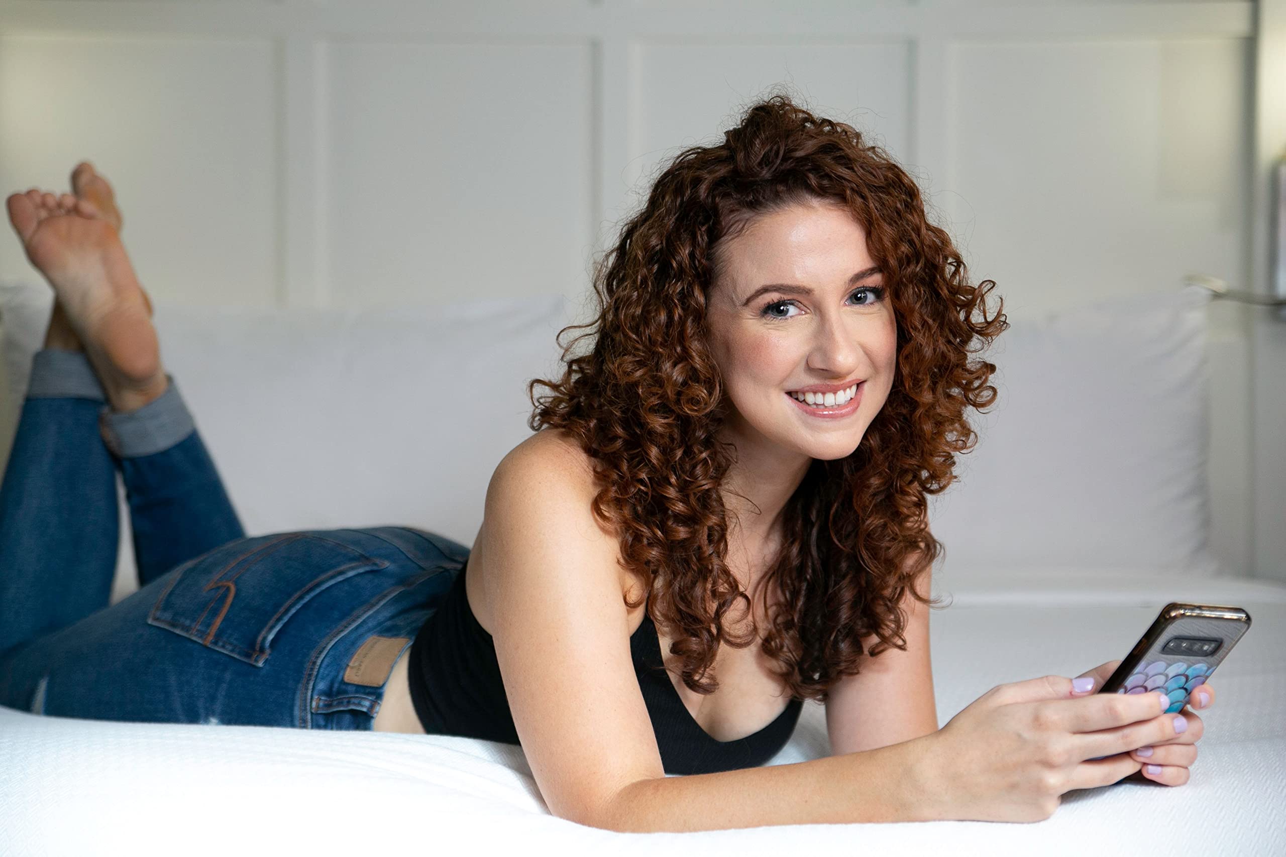 Curly Girl cream on damp hair defining curls.