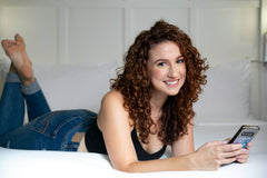 Curly Girl cream on damp hair defining curls.