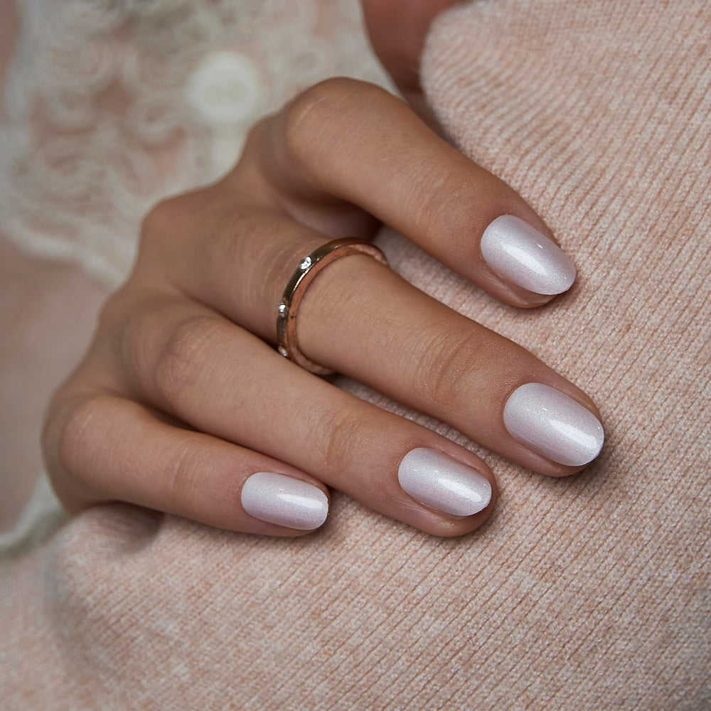 Curvlife short oval Moonlight Pearly Shimmer nails with a glossy white finish for everyday wear.